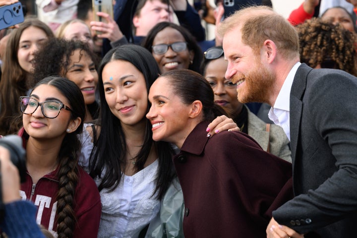 Meghan and Harry smiled and posed for selfies. 