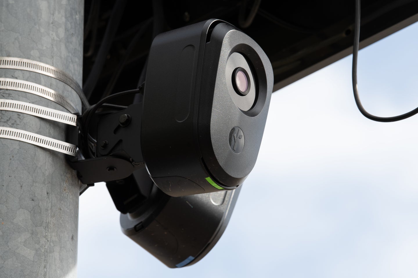 A close-up view shows the lens housing and camera unit of a solar-powered Flock Safety automated license plate reader in Santaquin, Utah.