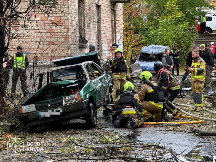 Emergency services personnel respond to a Russian air attack in kyiv, Ukraine, on Thursday.