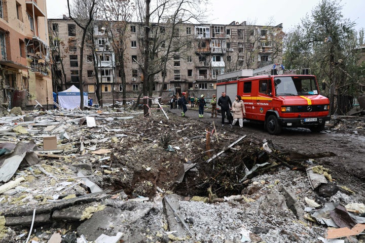 People walk past a crater in front of a residential building damaged by a Russian airstrike in Zaporizhzhia, Ukraine, Saturday, Oct. 17, 2026. (AP Photo/Kateryna Klochko)