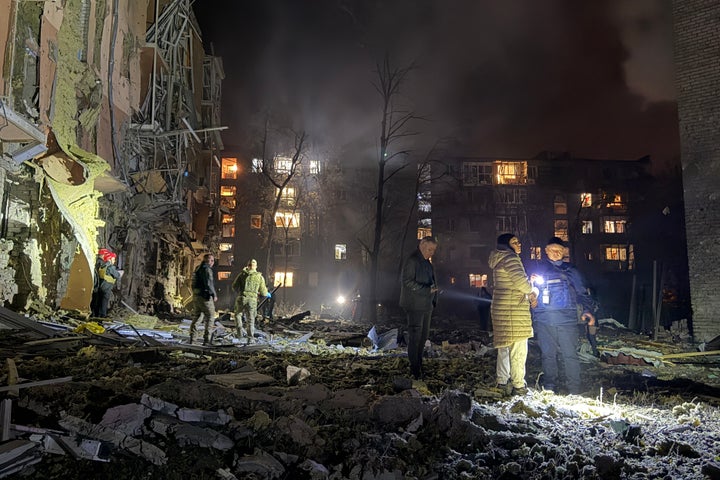 Local residents react as they stand among rubbles of residential buildings damaged following a Russian missile attack in Zaporizhzhia, on October 17, 2026, amid the Russian invasion of Ukraine. (Photo by Daria Nazarova / AFP via Getty Images)