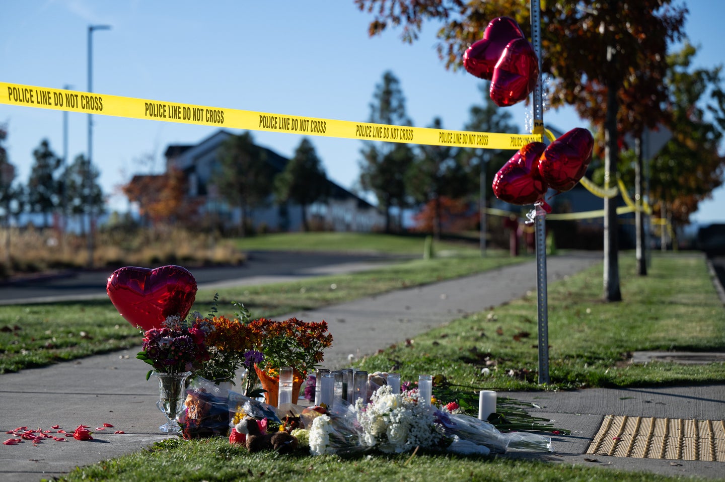 Flowers and candles are seen at a makeshift memorial outside Silver Rail Elementary in Bend, Ore., Friday, Oct. 16, 2026, a day after a deadly shooting. (AP Pho