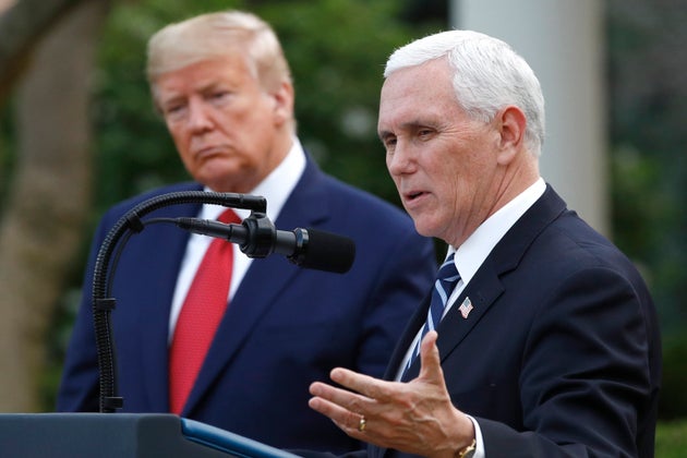 Donald Trump listens to then-Vice President Mike Pence in the Rose Garden of the White House in 2020.