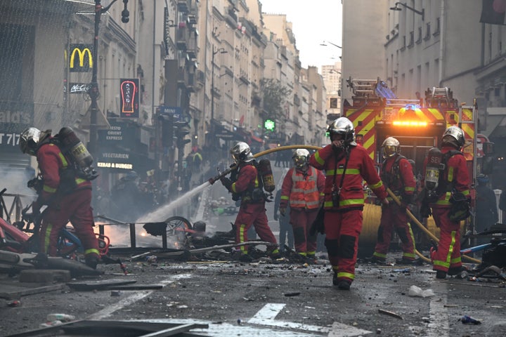 Firefighters extinguish a fire after a demonstration against rising living costs, joining students' grievances, in Paris, on Oct. 17, 2026.