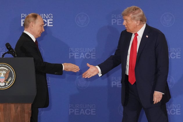 Donald Trump shakes Vladimir Putin’s hand in Alaska last year.