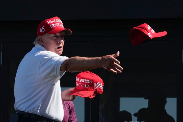President Donald Trump throws autographed hats to the crowd during the final round of a LIV Golf tournament at his Bedminster, New Jersey, golf club in August 2023. 