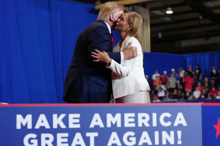 President Donald Trump greets Sen. Darline Graham (R-S.C.) at a campaign rally at the T. Ed Garrison Arena on Wednesday in Pendleton, South Carolina.