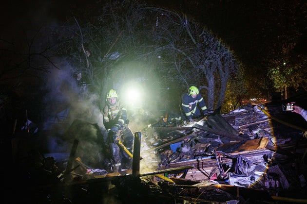 Rescue workers put out a fire at a residential house destroyed in a Russian missile strike on Kyiv, Ukraine, Wednesday, Oct. 21, 2026. (AP Photo/Evgeniy Maloletka)