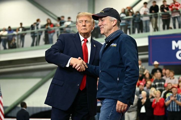 Trump shakes hands with Sen. Dan S. Sullivan (R-Alaska) as he invites him to speak during a campaign rally at Curtis D. Menard Memorial Sports Center in Wasilla, Alaska, on Oct.13, 2026. 