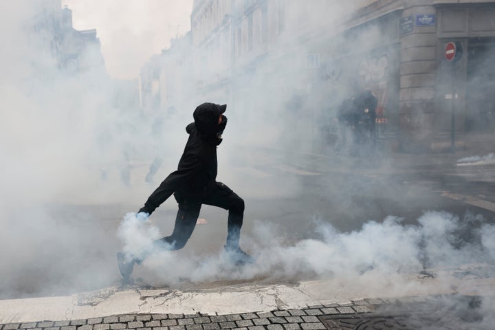 A protester throws a teargas canister to police after a demonstration against rising living costs in Rennes, France, Saturday, Oct. 24, 2026. (AP Photo/Jeremias Gonzalez)