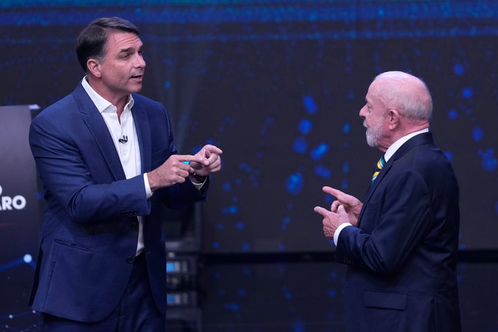 Opposition presidential candidate Sen. Flavio Bolsonaro, left, and Brazilian President Luiz Inacio Lula da Silva gesture toward each other during a televised presidential debate one week before the presidential runoff election in Sao Paulo, Brazil, Sunday, Oct. 18, 2026. (AP Photo/Andre Penner)