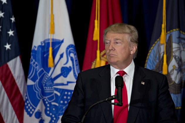 Donald Trump in front of a microphone looking ready to address an audience.