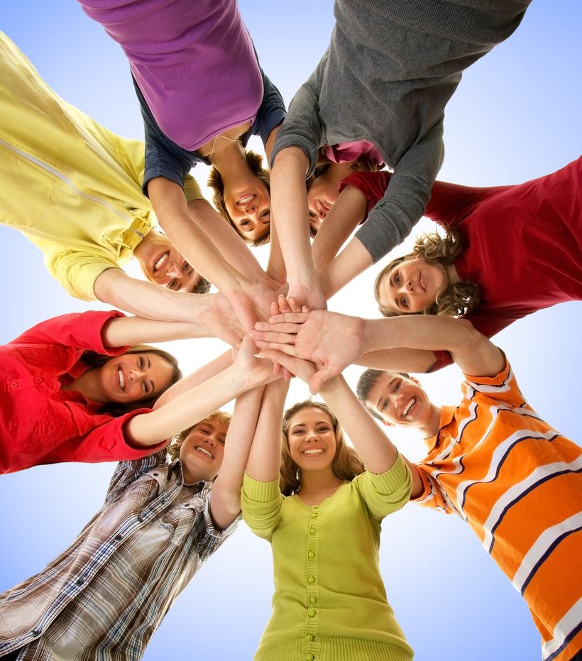 students in circle with hands together