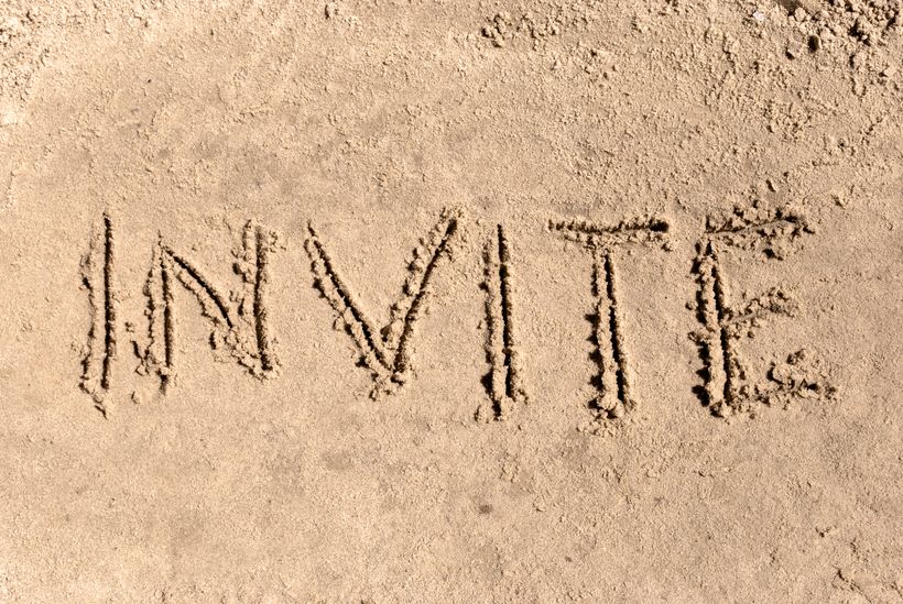 INVITE written in the sand