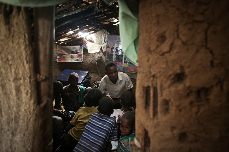 <span class='image-component__caption' itemprop="caption">John Keko Mututua, 16, studies with children from the village in his small hut in the town of Suswa, Kenya. Power provides myriad opportunities, both large and small, to rural parts of Africa. </span>